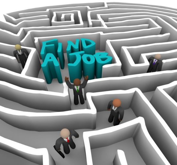 Several business people wander through a maze looking for a job
